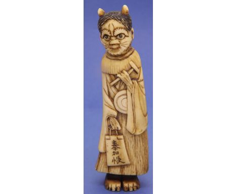 Unusual Ivory carved netsuke in the form of a horned cat lady with bag and hammer, H: 95 mm, signed to front. P&amp;P Group 1