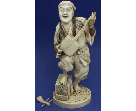 Carved ivory figure of a lute player standing on a chest, H: 180 mm, signed in panel to base. Lute end is broken off but pres