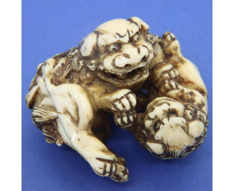 Ivory carved netsuke in the form of two fighting dogs, L: 52 mm, unsigned. P&amp;P Group 1 (£14+VAT for the first lot and £1+