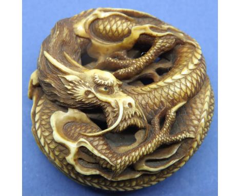 Ivory carved netsuke in the form of a circular dragon, D: 48 mm, signed to base. Overall good condition with no damages or sp