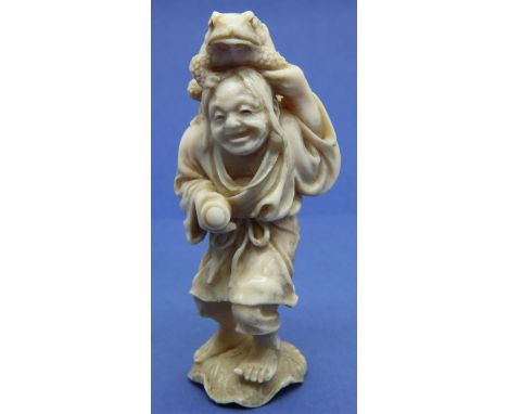 Ivory carved netsuke in the form of a standing man with a toad on his head, H: 67 mm, unsigned. P&amp;P Group 1 (£14+VAT for 