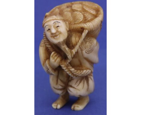 Ivory carved netsuke in the form of a bearded standing man carrying a sack, H: 42 mm, signed to base. P&amp;P Group 1 (£14+VA
