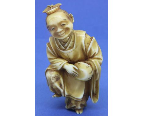 Ivory carved netsuke in the form of a standing man with a drum, damage to the top of hat, H: 62 mm, signed to back. P&amp;P G