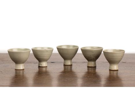 Leach pottery (St. Ives)Five studio pottery standard ware stem wine cups, with celadon glaze, impressed marks to the base, 7c