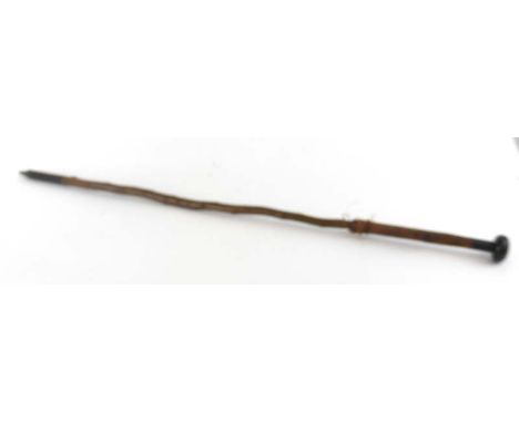 A makila shepherds stick with leather handle, ebonised pommel and metal bound base