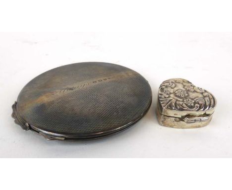 A silver engine turned compact, maker B&Co. Birmingham 1946, d. 7 cm, together with a metalware repousse decorated pill conta