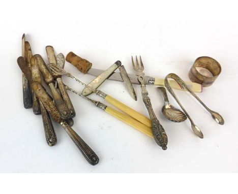 A mixed parcel of silver including a caddy spoon with shell bowl, a napkin ring, teaspoons, a silver mounted Moroccan leather