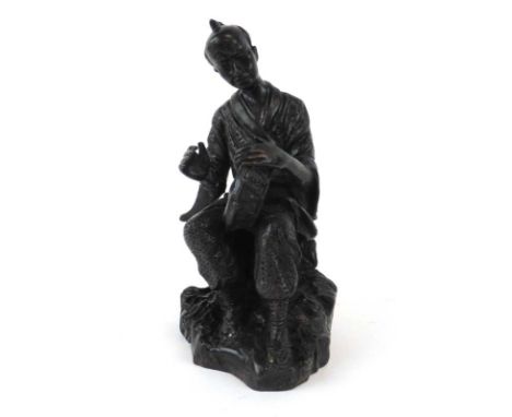 A Chinese brown patinated bronze figure modelled as a seated musician, h. 23 cm
