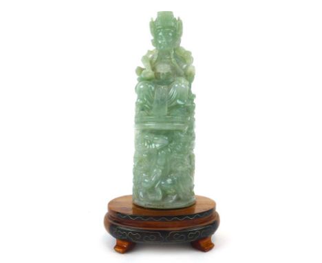A Chinese pale green jade carving modelled as an emperor seated on his throne on an oval base, overall h. 19.5 cm CONDITION R