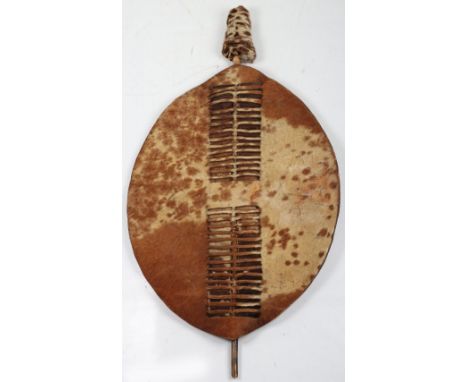 Zulu Cow Hide Shield Ishilunga of Conventional Form, white and light brown coloured, the former flecked with light brown, cen