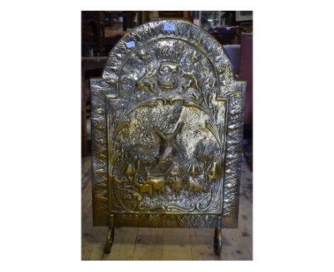 A brass firescreen, with embossed decoration, 90 cm high