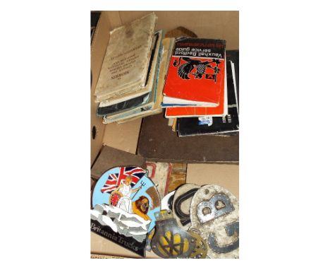 Assorted automobilia, including a Britannia Trucks pictorial enamel bonnet insignia, handbooks and various models including M