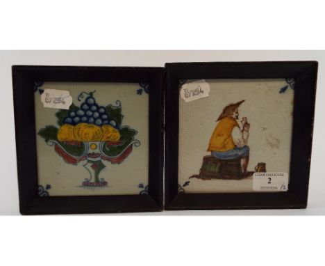 A Delft polychrome tile, decorated a gentleman playing cards, 12 cm square, and another similar, decorated a basket of fruit 
