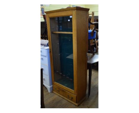 An oak gun cabinet, with a glazed door, 69 cm wide, an Art Deco style dwarf longcase clock, a mahogany chest of drawers, and 