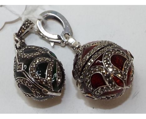 A silver marcasite and enamel locket, in the form of an egg, and another (2)