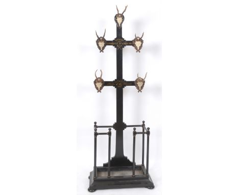 A hunting lodge style hallstand, with mask hooks and painted inscription, 222 cm high  See illustration