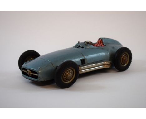 A JNF Mercedes-Benz W-196 tinplate friction drive racing car, with chromed side exit exhausts, and lithograph printed dashboa