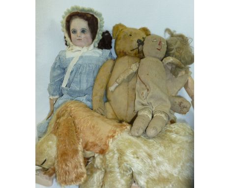 A vintage plush teddy bear (extremely worn), an early 20th century doll with moving eyes and composite face, another early 20