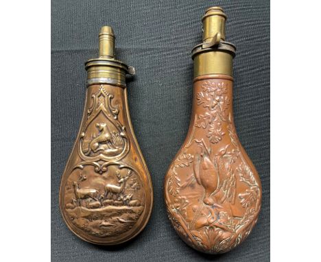 A Brass and Copper Powder Flask embossed with a design of game birds and oakleaves. Four adjustable measures of black powder 