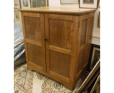 An early to mid 20th Century oak livery cupboard with two doors enclosing six linen shelves CONDITION REPORTS Numerous surfac