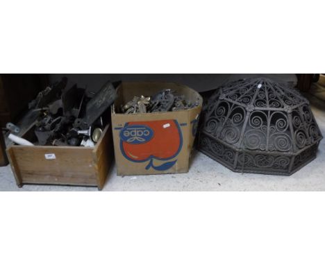 A wrough iron light shade with scroll work decoration, a box of plaster embellishments of scrolling design and a box of vario