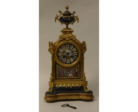 A 19th Century gilt brass cased mantel clock the eight day movement by Japy Freres of Paris the circular painted porcelain di