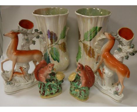 A collection of Staffordshire pottery to include a pair of stag spill vases, a pair of black and white spaniels, a pair of sq