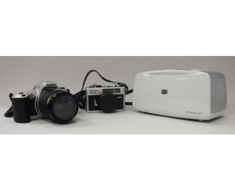 A Canon EOS 500 camera, a Ricoh 500g camera and an HP photosmart 375 printer