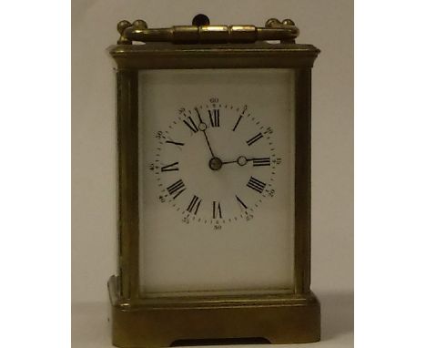 A circa 1900 French brass cased carriage clock the movement with visible escapement striking on a gong, No'd. 1144 the dial w