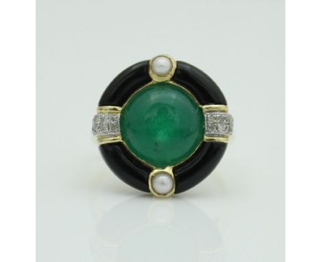 An unmarked 18 carat gold dress ring in the Art Deco manner, set with central cabochon cut jade centre with black enamel pear