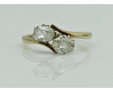 An 18 carat gold two stone diamond ring, approx 0.9 carat total, approx 2.6 g, size O