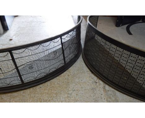 A 19th Century pierced steel brass mounted curved fireguard and a similar steel and wirework fireguard