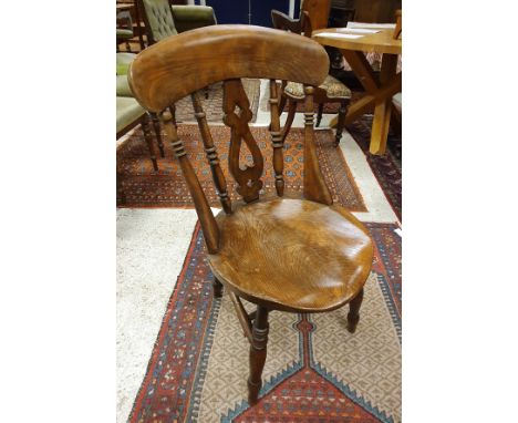 A set of six beech and elm stick back kitchen chairs with circular seats