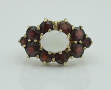 A late 20th Century 9 carat gold opal and garnet set cluster ring in the Victorian taste, size Q/R, approx 6.7 g