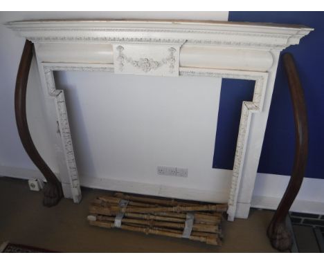 A painted fire surround in the Georgian style, a pair of mahogany newel posts with lion paw feet and various pine spindles