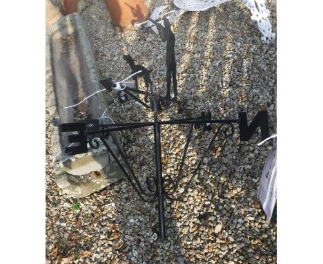 A modern iron weather vane decorated with shooting man and gun dog