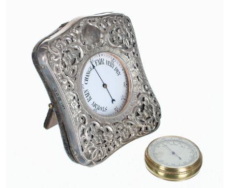 Goliath type nickel cased pocket barometer, within a folding foliate pierced silver travelling case; also a brass cased pocke