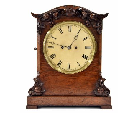 English oak double fusee bracket clock striking on a bell, the 8" cream dial within a foliate carved stepped case with wavy c