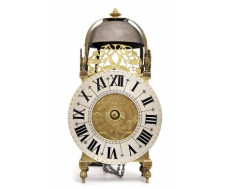 Continental brass lantern clock, the 6.75? silvered dial enclosing a foliate engraved centre, surmounted by pierced dolphin f