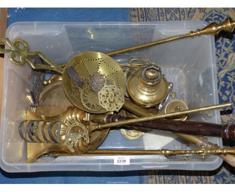 A quantity of brass ware including fire irons, horse brasses, oil lamp base etc.