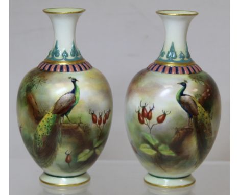 Pair of Royal Worcester Hadley Ware small porcelain vases of baluster form decorated with peacocks in polychrome enamels, fra