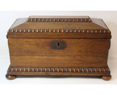 19th century rosewood veneered tea caddy of sarcophagus form with beaded borders, twin ring handles and circular knop feet, t