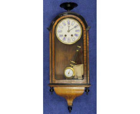 19th century pendulum wall clock with blue &amp; white roman numeral dial. oak cased with black urn finial.