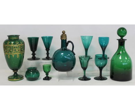 Eleven pieces of 19th century and later green glass comprising: decanter of globe and shaft form with single handle and brass