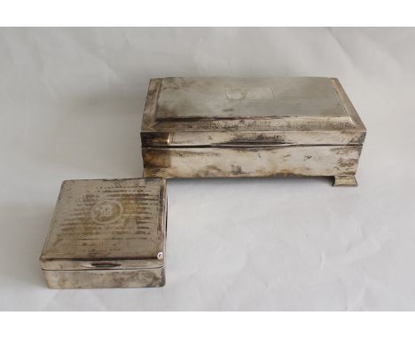 Silver engine turned cigarette box on bracket feet, 19cm and another smaller. (2)