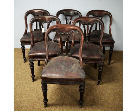 A set of six Victorian mahogany spoon back dining chairs, the arched top rail with scrolling splats above padded feet, raised