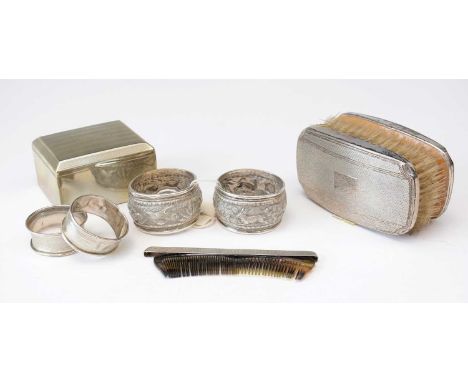 A pair of silver-mounted clothes brushes; a pair of Indian white metal napkin rings, decorated with dogs chasing quarry; two 