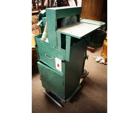 A 20th Century floor standing sander, painted green and containing various tools and accessories, 114 x 39 x 62cms deep.