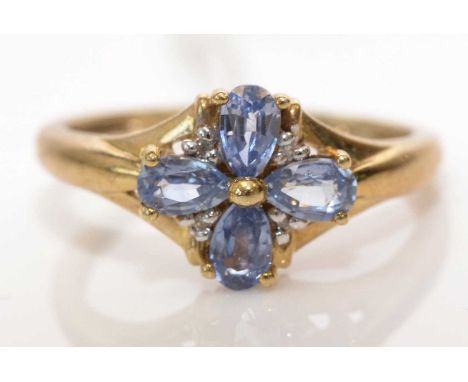 A Ceylon sapphire and diamond ring, set with four pear-cut sapphires surrounded by small diamonds, on 9ct. yellow gold shank,