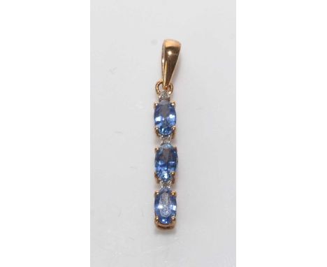 A Ceylon sapphire pendant, set with three oval facet-cut sapphires parted by diamonds, in 9ct. yellow gold mount, 2.6cms high